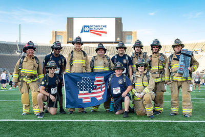 Clay firefighters waive a patriotic Notre Dame flag at 