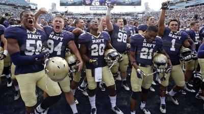 Navy's football players celebrate after their 2016 victory over Notre Dame in Jacksonville, Fla. (Associated Press file)