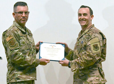 U.S. Air Force Brig. Gen. Sean Choquette, left, 12th Air Force (Air Force Southern) vice commander, awards Maj. Michael Madden, 563d Rescue Group HH-60G Pave Hawk pilot, the Distinguished Flying Cross with Valor. Photo Credit: Airman 1st Class Devlin Bishop